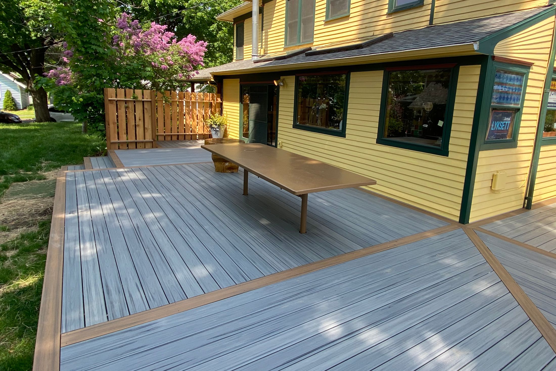 Completed wraparound composite deck on a restored home